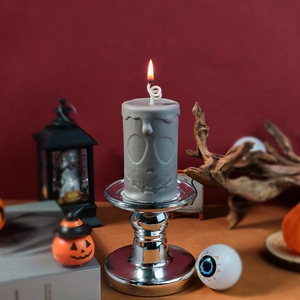 Detailed view of Jack Skellington carved candle with wax dripping effect on silver stand