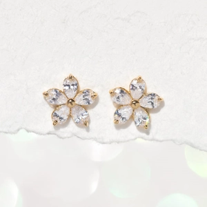 Minimalist five-petal flower stud earrings in gold with sparkling white cubic zirconia