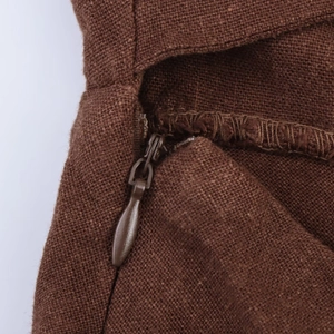 Macro view of a brown linen blend dress showing high-quality invisible zipper detail