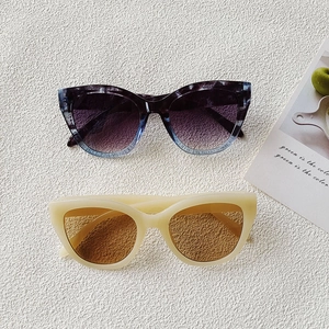 Chic small frame cat eye sunglasses in purple gradient and beige on white background