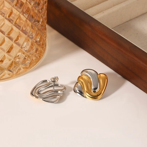 Geometric irregular wave earrings with two-tone gold and silver finish in a luxury display