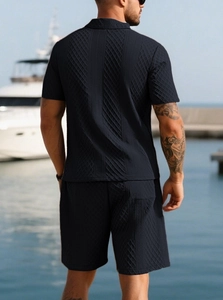 Men's navy polo set featuring intricate geometric textured knit fabric and relaxed fit