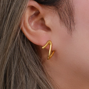 Close-up of golden stainless steel zigzag earrings with a minimalist geometric design