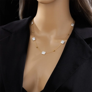 Elegant gold titanium necklace with square pearls and beads on a minimalist fine chain