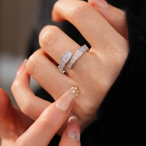 Detailed macro view of silver snake-shaped open ring with cubic zirconia micro-pave setting