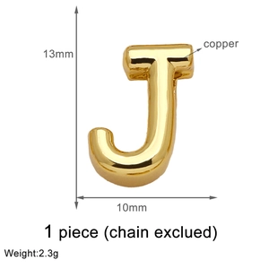Macro view of gold plated copper letter J pendant showing 13mm size and weight