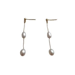 Elegant long gold chain earrings with natural baroque freshwater pearls on white background