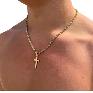 Men's gold stainless steel cross pendant necklace with twist rope chain on male model