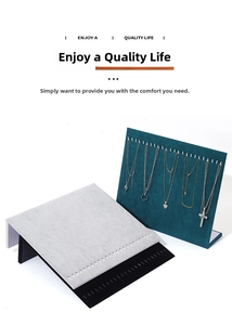 Close-up of L-shaped velvet jewelry displays with multiple slots for necklaces in three colors