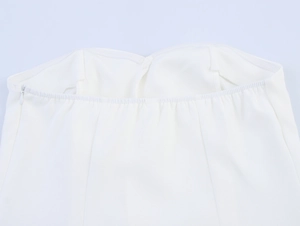 Detail of the white bandeau top with invisible zipper and elastic top edge structure