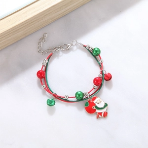 Close-up of Christmas bracelet with Santa charm, bells and red-green braided rope