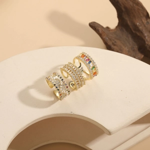 Three 14K gold plated open rings with colorful cubic zirconia and pearls on ivory stand