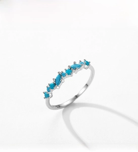 Detail of S925 silver ring with marquise and round turquoise stones in a minimalist design