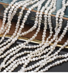 Macro shot of 4-5mm baroque freshwater pearls with natural cream white luster
