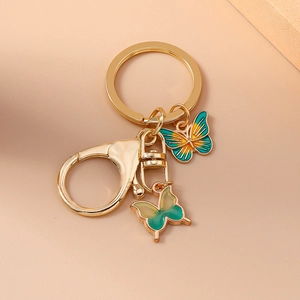Creative butterfly keychain with teal and green gradient enamel charms on gold ring