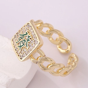 Detail of 18K gold ring featuring micro-pave zircons and green 'Fa' character design