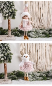 Detail of plush Christmas ornaments featuring a pink fairy and reindeer with gold shoes
