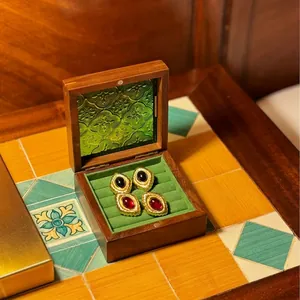 Vintage walnut wood jewelry box with green embossed glass lid and velvet interior