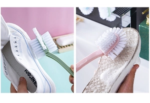 Close-up of dual-head cleaning brush with stiff bristles scrubbing shoes in water