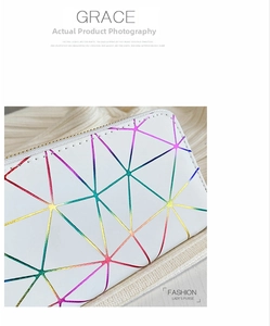 Detail of white faux leather clutch featuring colorful geometric rainbow triangle patterns