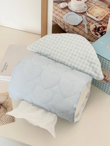 Close-up of light blue quilted tissue bag with heart patterns and blue plaid detail