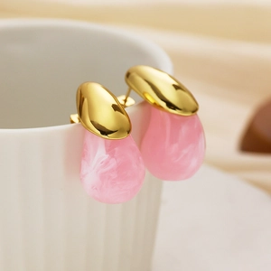 Macro shot of 18k gold plated stainless steel earrings with pink marble resin droplets