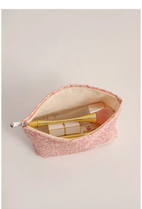 Interior detail of pink leopard print cosmetic bag showing spacious storage for brushes