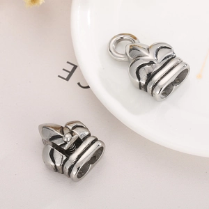 Detailed macro view of vintage silver stainless steel end caps with floral relief design
