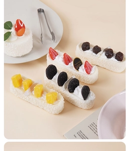 Macro shot of realistic PU cream cake dessert model with strawberry and mango toppings