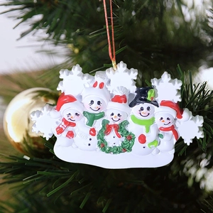 Resin 5-member snowman family hanging ornament on a Christmas tree branch