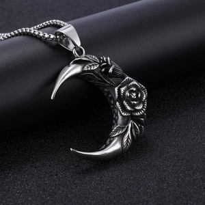 Macro detail of gothic crescent moon rose pendant with intricate vintage relief carvings
