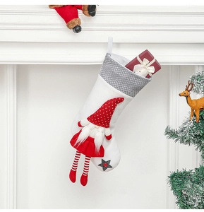 Close-up of Nordic gnome Christmas stocking with grey star on white fireplace mantle