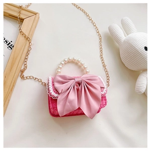Pink tweed girls bag with pearl handle and bow, shown with a knit bunny toy
