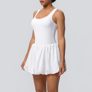 Detail of white cooling tennis dress with pleated bubble skirt and racerback design