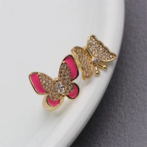 Macro view of gold butterfly ring with pink enamel and micro-pave cubic zirconia