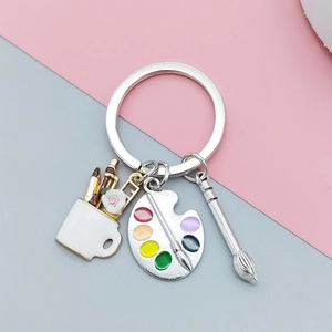 Art theme keychain featuring enamel artist palette, paintbrush, and flower mug charm