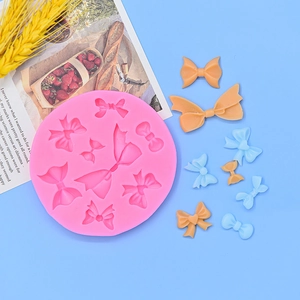 Pink silicone mold for 3D bowknot shapes, ideal for cake fondant and resin craft DIY