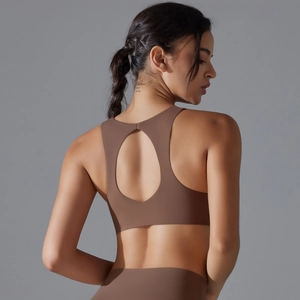 Detail of mocha brown sports bra featuring a back cutout and high-stretch fabric