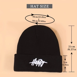 Detail of embroidered graffiti Heart lettering on a black knitted cuffed beanie hat