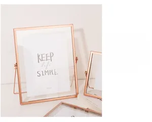 Detail view of a 6x8 inch rose gold metal picture frame with polished finish and glass pane