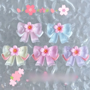 Macro shot of assorted translucent resin cherry blossom bow charms in macaron colors