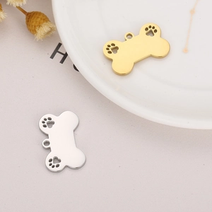Dog bone pendants in gold and silver finish with hollow paw prints for DIY jewelry