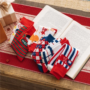 Close-up of festive red cotton socks with holiday patterns and Chinese characters