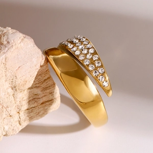 Gold wrap ring with polished surface and pavé cubic zirconia on natural stone