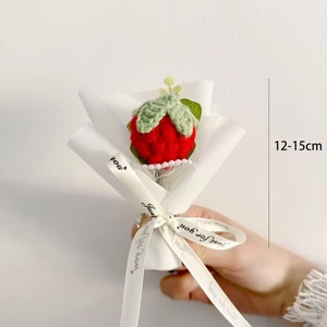 Handmade crochet red strawberry bouquet with white paper wrap and decorative ribbon