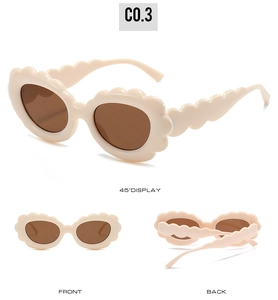 Detail view of oval cream sunglasses featuring a unique sunflower wavy flower frame design