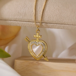 18K gold-plated necklace with white shell heart pendant, arrow, and cross details