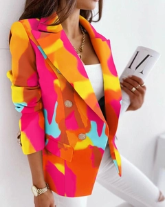 Dettaglio di un blazer tie-dye colorato con bottoni dorati lucidi a doppio petto
