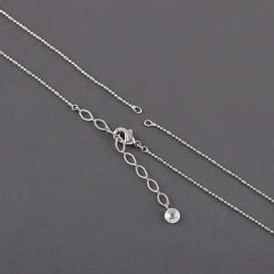 Detail of silver rhodium-plated cross chain with lobster clasp and extension link