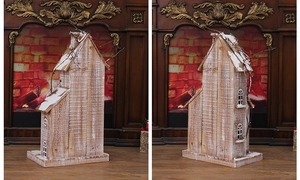Close-up of a rustic wooden Christmas house with snow spray and chimney detail